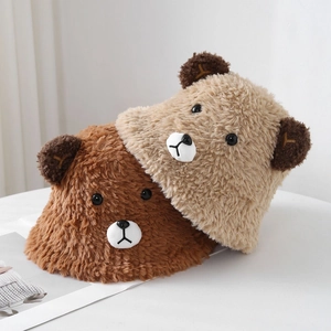 Detail of plush bear bucket hats in brown and beige colors with cute 3D ears and embroidery