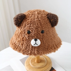 Cute brown plush bear bucket hat with 3D ears and warm fleece texture for winter fashion