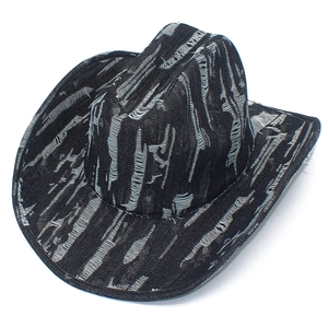 Close-up of distressed black denim cowboy hat with vintage frayed textures and zebra-like pattern