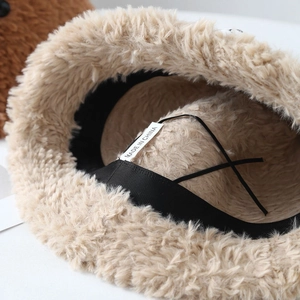 Detail view of plush bucket hat interior showing adjustment straps and inner lining