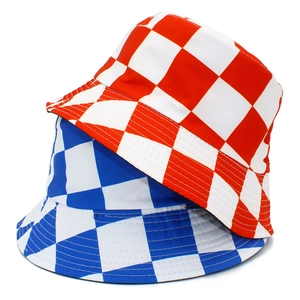 Detailed view of red and blue checkerboard bucket hats stacked on white background