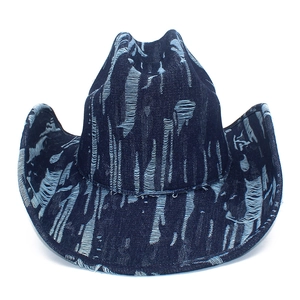 Distressed dark blue denim western cowboy hat with vintage ripped texture and wide brim
