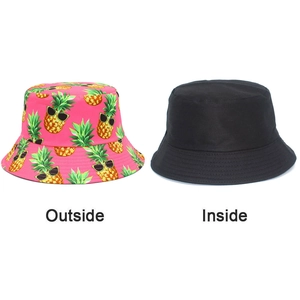 Detailed view of the reversible pink pineapple bucket hat with black inner side