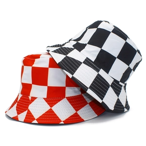 Close-up of reversible checkered bucket hats in red and black cotton canvas fabric