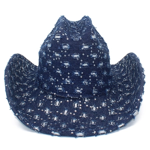Distressed dark blue denim cowboy hat with sequins and ripped details on white background