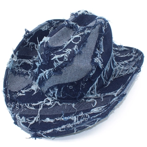Detailed macro shot showing distressed frayed texture and denim fringe on navy fedora hat