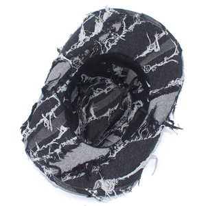 Close-up of distressed denim sun hat showing frayed edges and internal sweatband detail