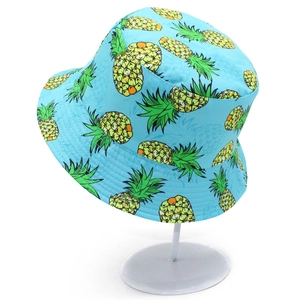 Detail of light blue bucket hat with yellow pineapple print and wide brim for sun protection