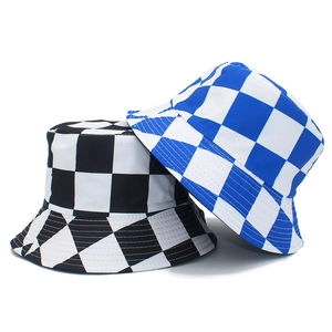 Detail view of reversible checkerboard bucket hats in black and bright blue canvas