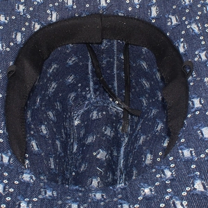 Detail of blue denim cowboy hat interior showing the black sweatband and adjustable drawstring