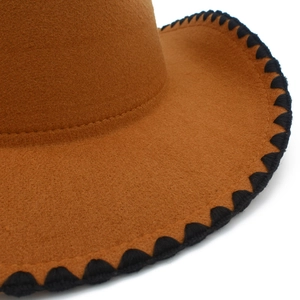 Detailed close-up of brown wool felt fedora featuring black wavy stitching on the wide brim