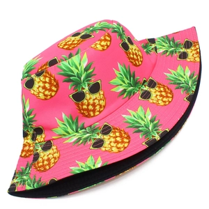 Close-up of vibrant pink bucket hat with sunglasses pineapple print and black lining