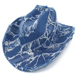 Detailed view of dark blue cowboy hat with distressed denim fabric and fringe edges