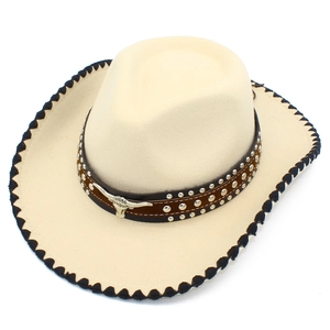Detailed top view of beige cowboy hat with silver rivets and metal bull head buckle