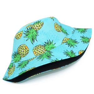 Close-up of vibrant pineapple print on light blue reversible bucket hat made of durable fabric