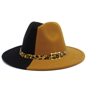 Detail of two-tone black and tan fedora with leopard print band and gold buckle