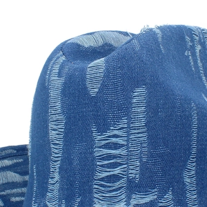 Blue denim cowboy hat with distressed texture and frayed cow skull metal accessory