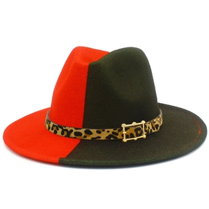 Detail of red and green fedora hat featuring leopard print band and golden buckle