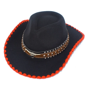 Detail of wool cowboy hat featuring red stitched edges and a bull head metal emblem