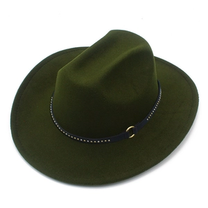 Detail view of dark green fedora with leather strap and metallic rivet studs