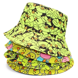 Neon green bucket hat with cartoon duck prints stacked on white background for sun protection