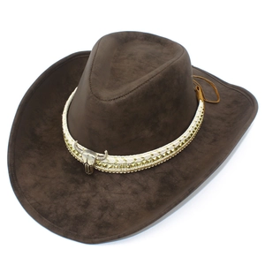 Detail of dark brown leather cowboy hat featuring a silver bull skull and gold studs