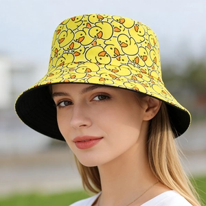 Detail of yellow bucket hat with cartoon duck print showing cotton fabric texture