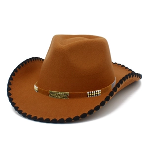 Macro shot of brown wool felt cowboy hat featuring Masonic symbol on metallic buckle