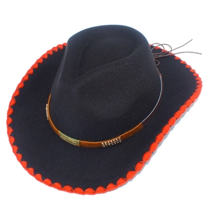 Detail of black wool fedora hat featuring red stitched edges and a decorative brown band
