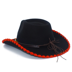 Detail view of black wool cowboy hat with red stitching and brown leather straps