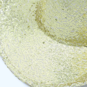 Detailed view of shimmering gold sequins on a western cowboy party hat accessory