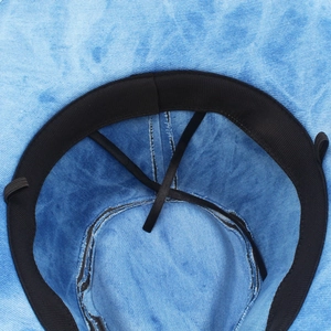 Detailed interior of light blue denim hat featuring a black sweatband and adjustable drawstring