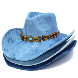 Vintage western cowboy hats with wide brims and turquoise bead accents on denim fabric