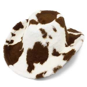 Close-up detail of plush cow print texture and curved brim on Western cowboy hat