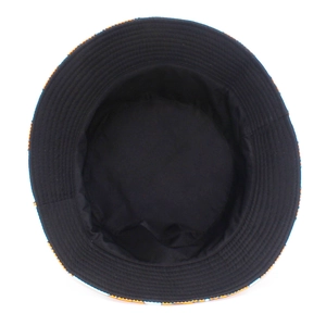 Detail view of cotton bucket hat featuring black inner lining and orange geometric brim