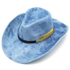 Detail of blue denim cowboy hat featuring snowflake wash and golden feather decoration