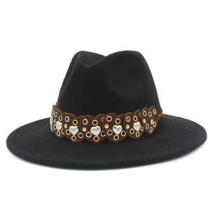Detail of black wool fedora featuring a brown leather band with heart cutouts and studs