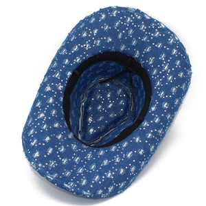 Close-up of blue denim cowboy hat with silver sequins and distressed frayed edge details