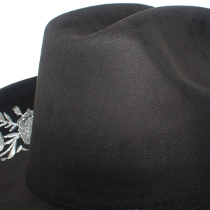 Macro detail of silver floral embroidery on a black high-quality suede jazz hat
