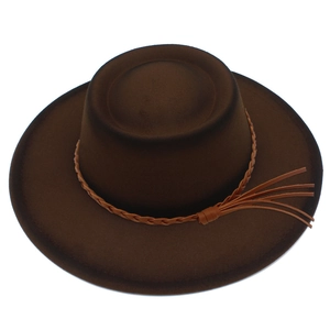Detail view of dark brown fedora hat with braided leather band and tassel accents