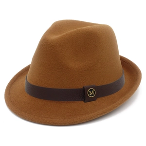 Close-up of camel fedora hat with brown leather band and gold M letter metal tag