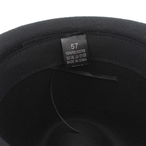 Detail shot of black felt hat interior with size 57 and 100% polyester fabric label