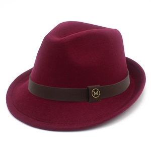 Detail view of the burgundy felt hat with brown leather band and gold M badge