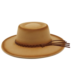 Detailed close-up of camel felt bolero hat featuring brown woven band and side tassel detail