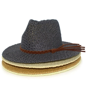 Detail of woven straw sun hats with breathable hollow texture and tassel braided band