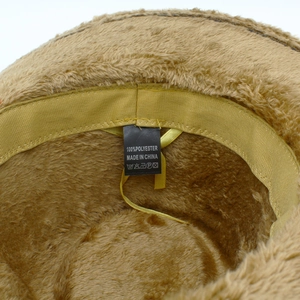 Brown fuzzy faux fur fedora hat featuring soft polyester lining and interior care label