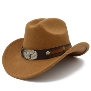 Detail of brown cowboy hat with leather band featuring bull head and turquoise ornaments