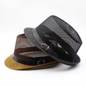 Detail of stacked summer fedora hats with breathable mesh texture and decorative buckle belt