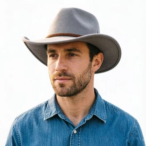 Detail of grey felt jazz hat with brown woven band and curved brim for casual style