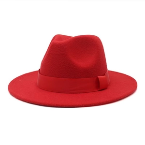 Detailed close-up of a red fedora wool felt hat with matching ribbon and side pleat